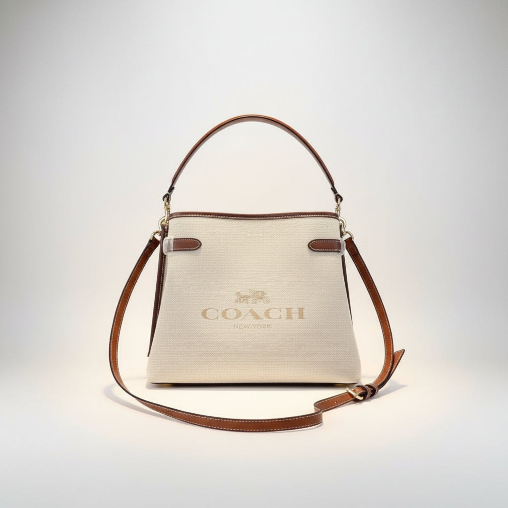Coach New York luxury leather handbag in beige with adjustable strap"