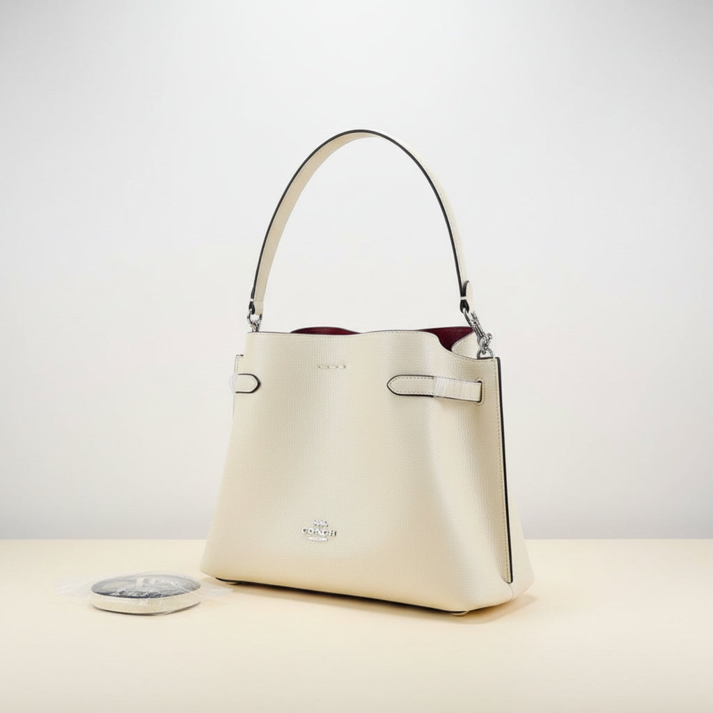 Side view of Coach crossbody bag displaying premium leather quality