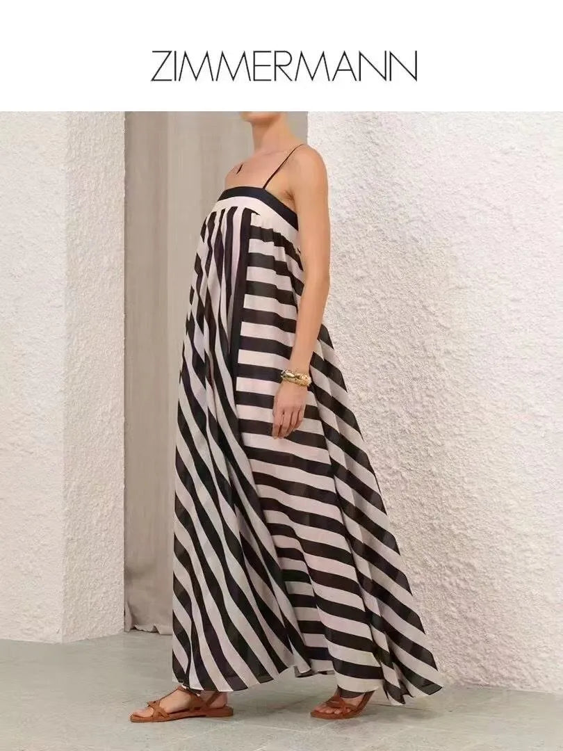 Woman wearing a black and white striped dress with 'Zimmermann' branding.
