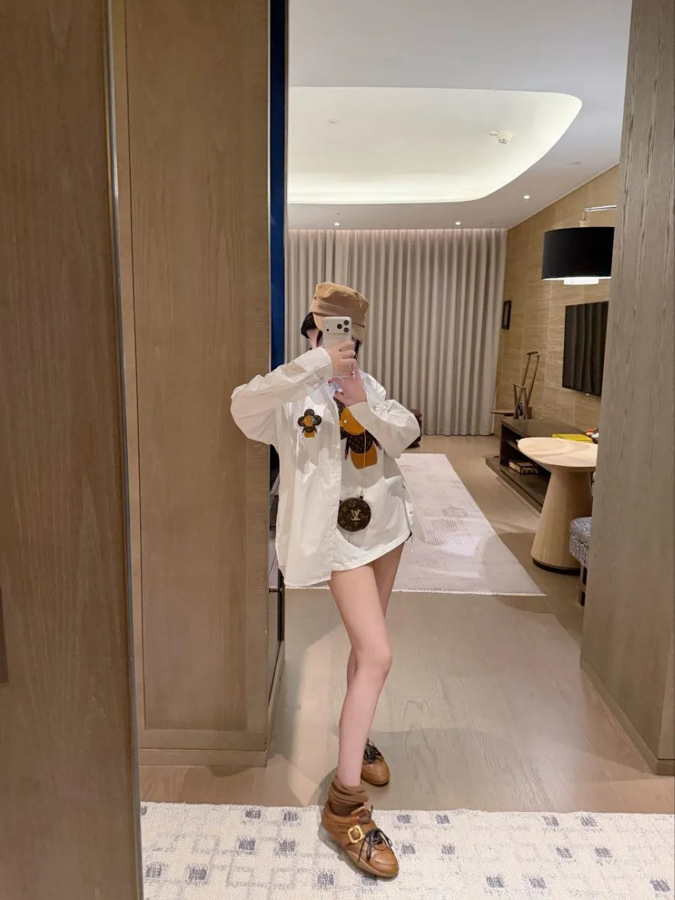 Person taking a mirror selfie in a modern interior setting