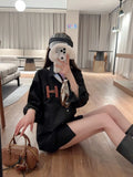 Person sitting on the floor in a modern living room taking a mirror selfie.