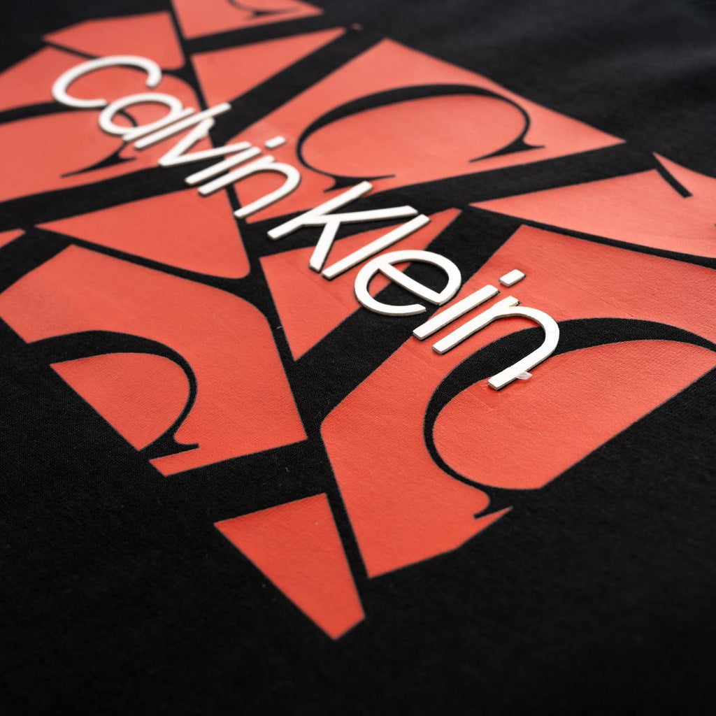Calvin Klein logo on a black and red patterned background