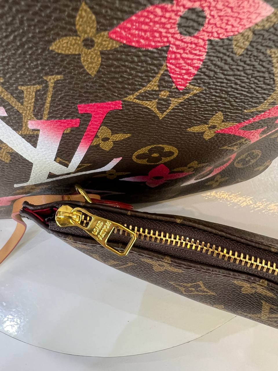 Louis Vuitton monogram handbag with floral design on a white background