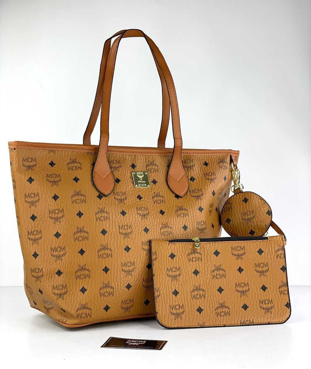 Brown handbag with matching pouch and round bag on a white background