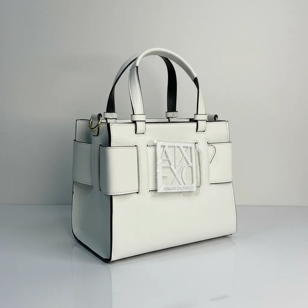 White handbag with a brand logo on a gray background
