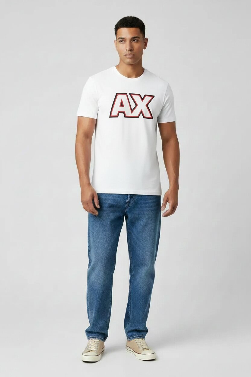 Man wearing a white t-shirt with a red logo and blue jeans on a light gray background