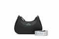 Black handbag with matching strap on a white background, featuring Armani Exchange logo.