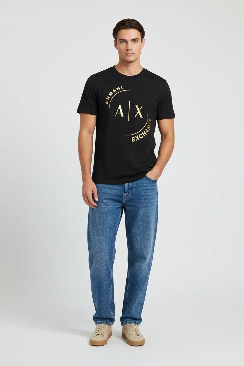 Male model wearing Armani Exchange black AX logo t-shirt with loose fit blue jeans and beige sneakers