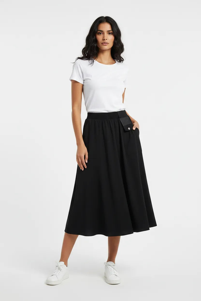 Woman wearing a black skirt and white top on a white background