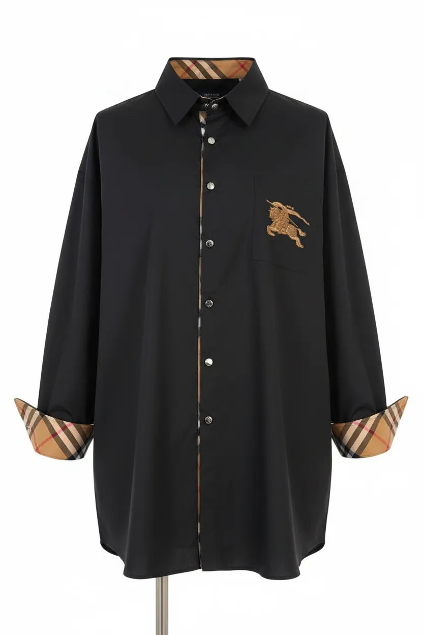 Black shirt with Burberry logo and checkered cuffs on a mannequin against a white background