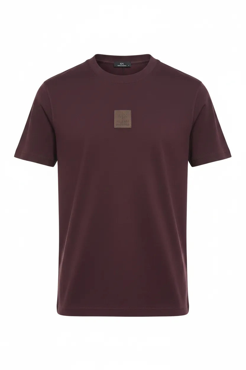 Maroon t-shirt with a small square logo on a white background