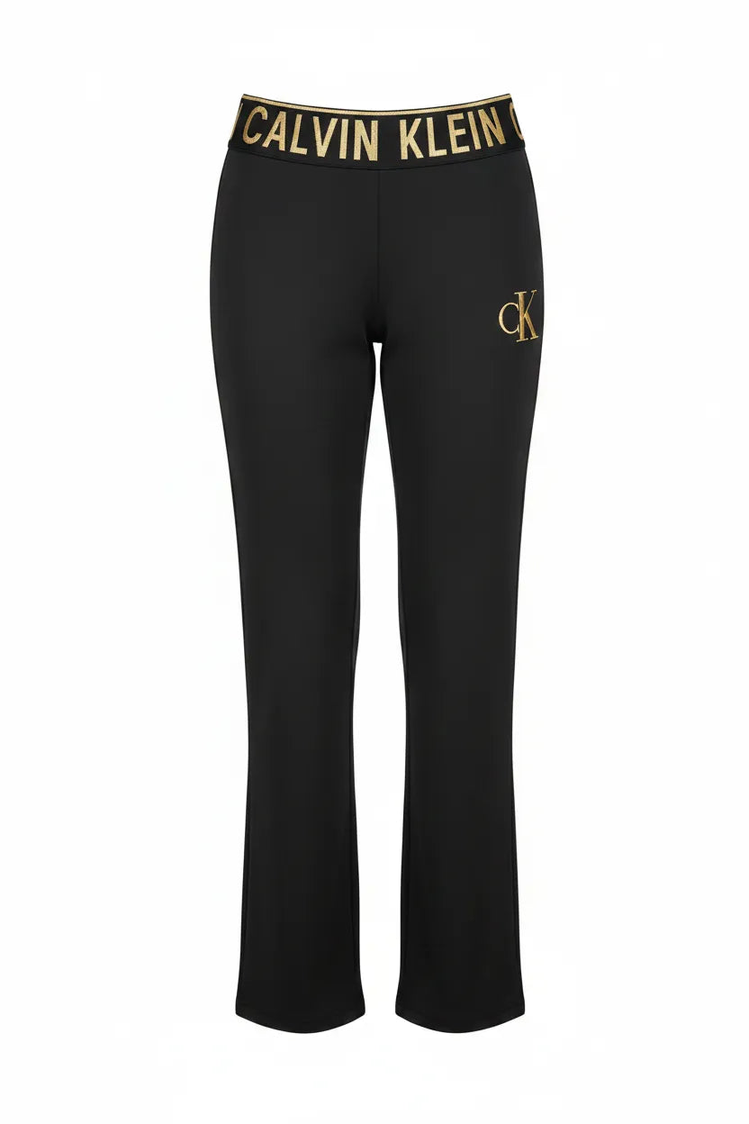 Calvin Klein black track pants gold CALVIN KLEIN waistband CK logo ghost mannequin studio white background