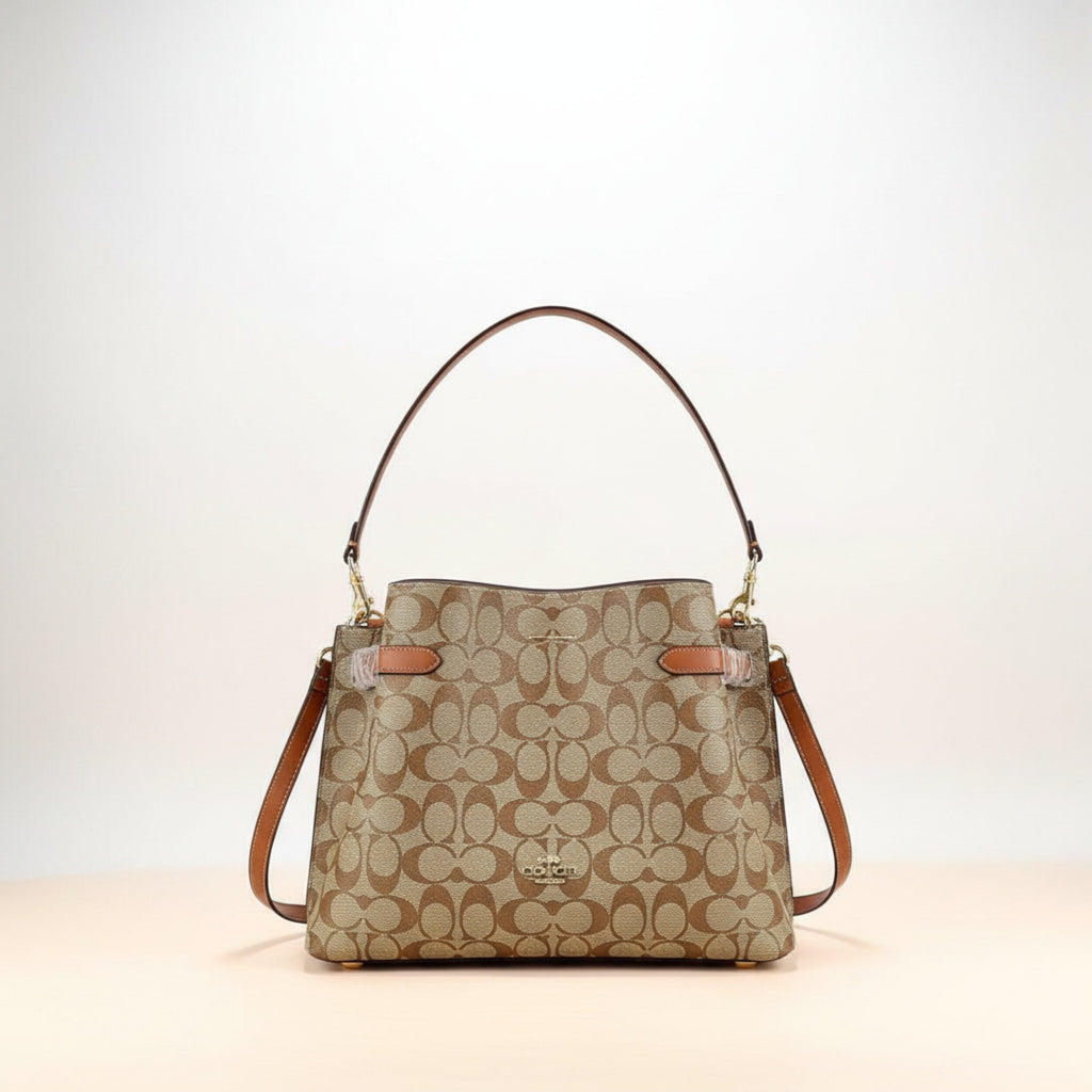 Coach signature canvas handbag in khaki and saddle brown with iconic C pattern and adjustable leather strap