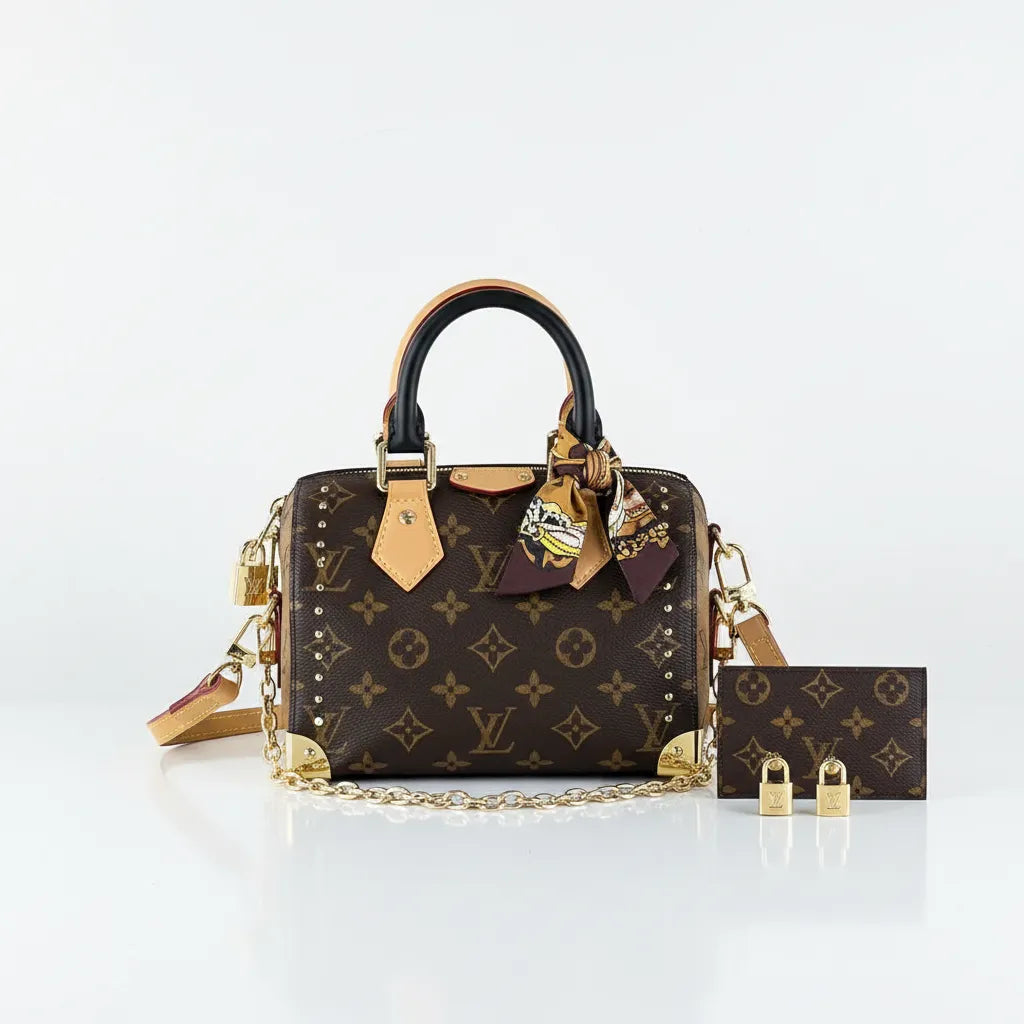 Designer handbag with monogram pattern and matching pouch on a white background