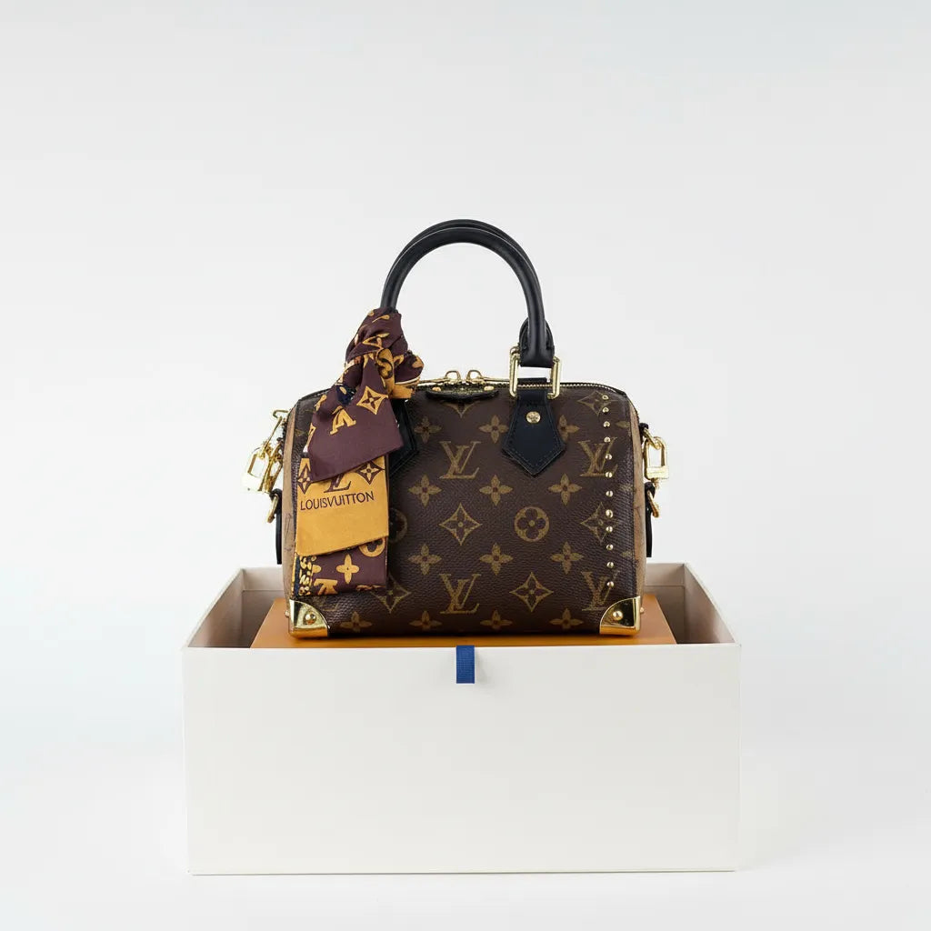 Louis Vuitton handbag with a matching scarf in a white box on a light gray background