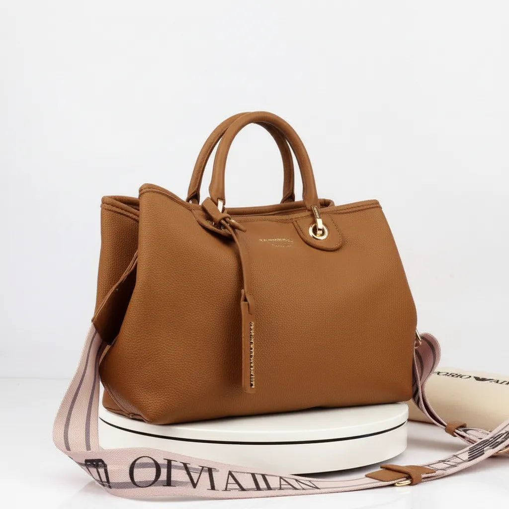 Brown handbag with a strap on a white background