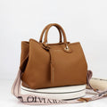 Brown handbag with a strap on a white background