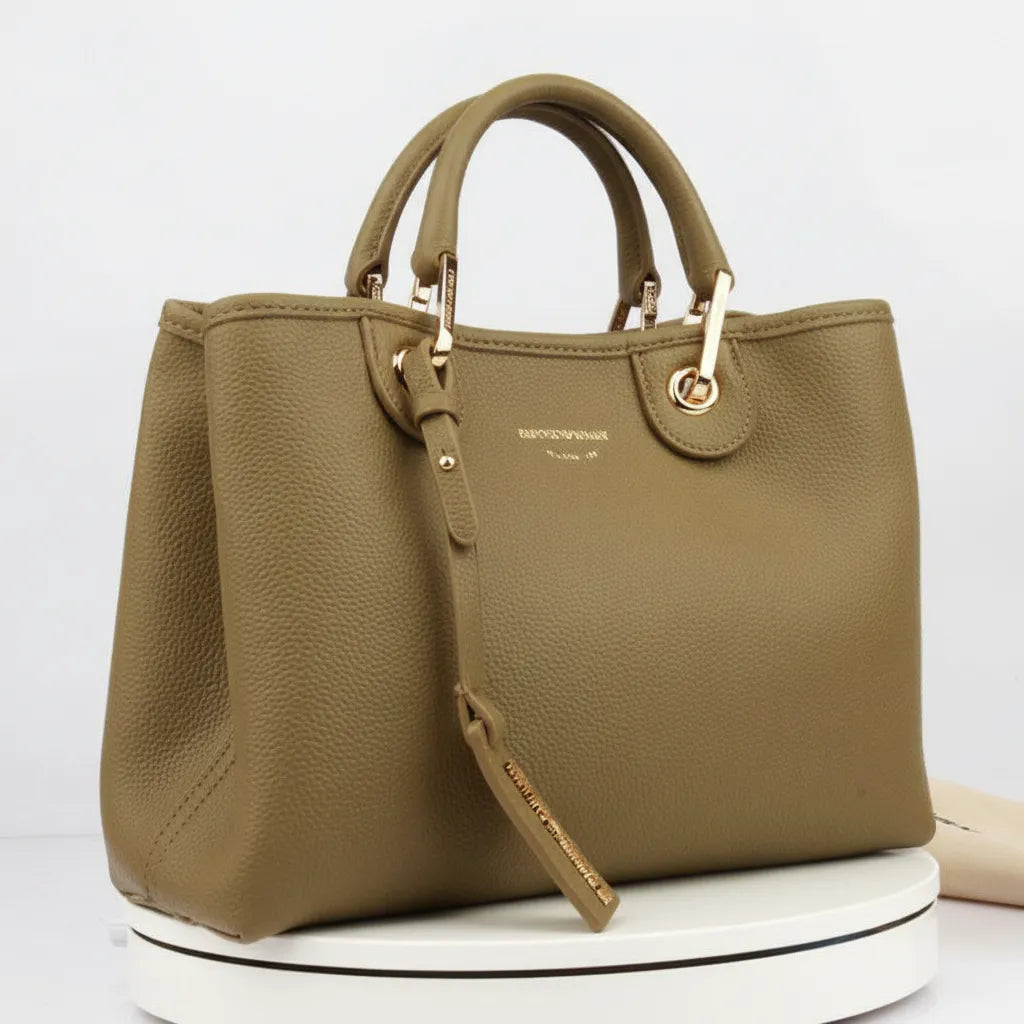 Brown handbag with gold accents on a white background