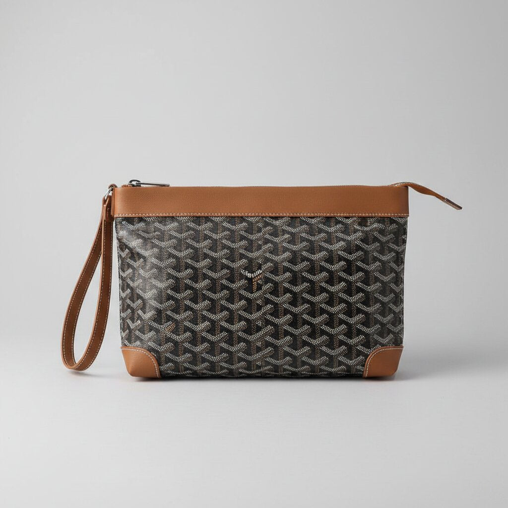 Goyard Senat Clutch Wristlet Bag in Black with Tan Leather Trim - Top View Showing Zipper and Wrist Strap - Light Gray Background