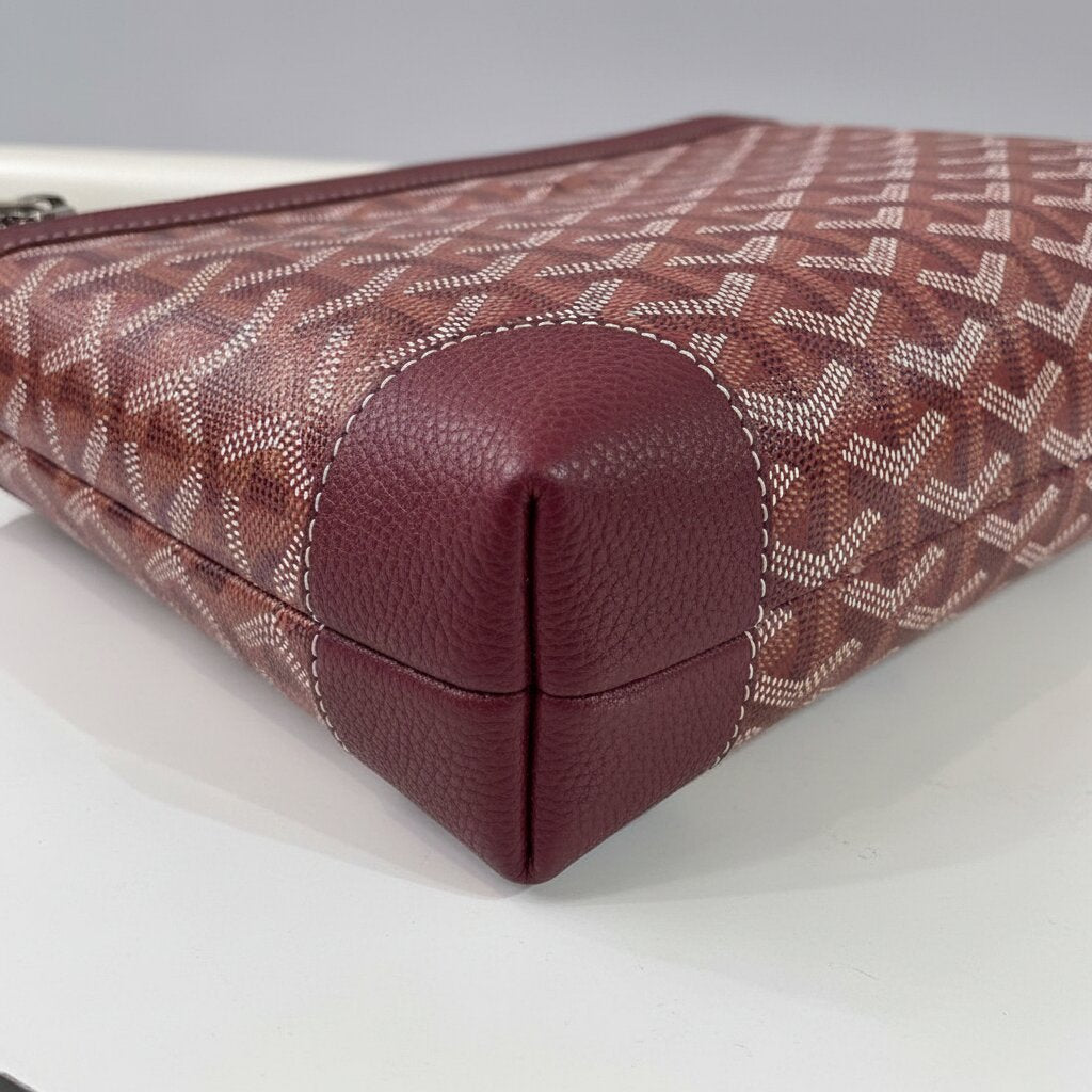 Goyard Senat Clutch Wristlet Bag in Burgundy - Close-up Bottom Corner and Canvas Texture Detail - Light Gray Background