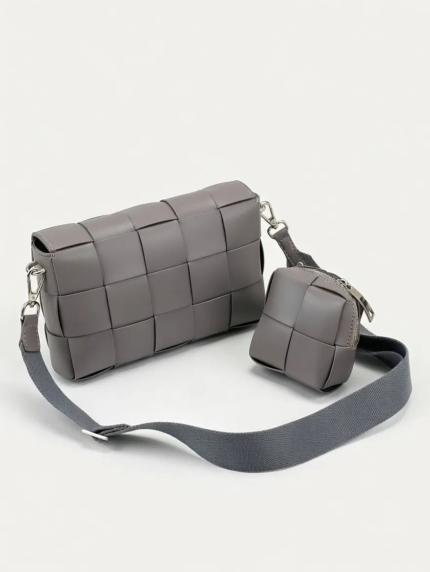 Gray woven handbag with a smaller matching pouch on a light gray background