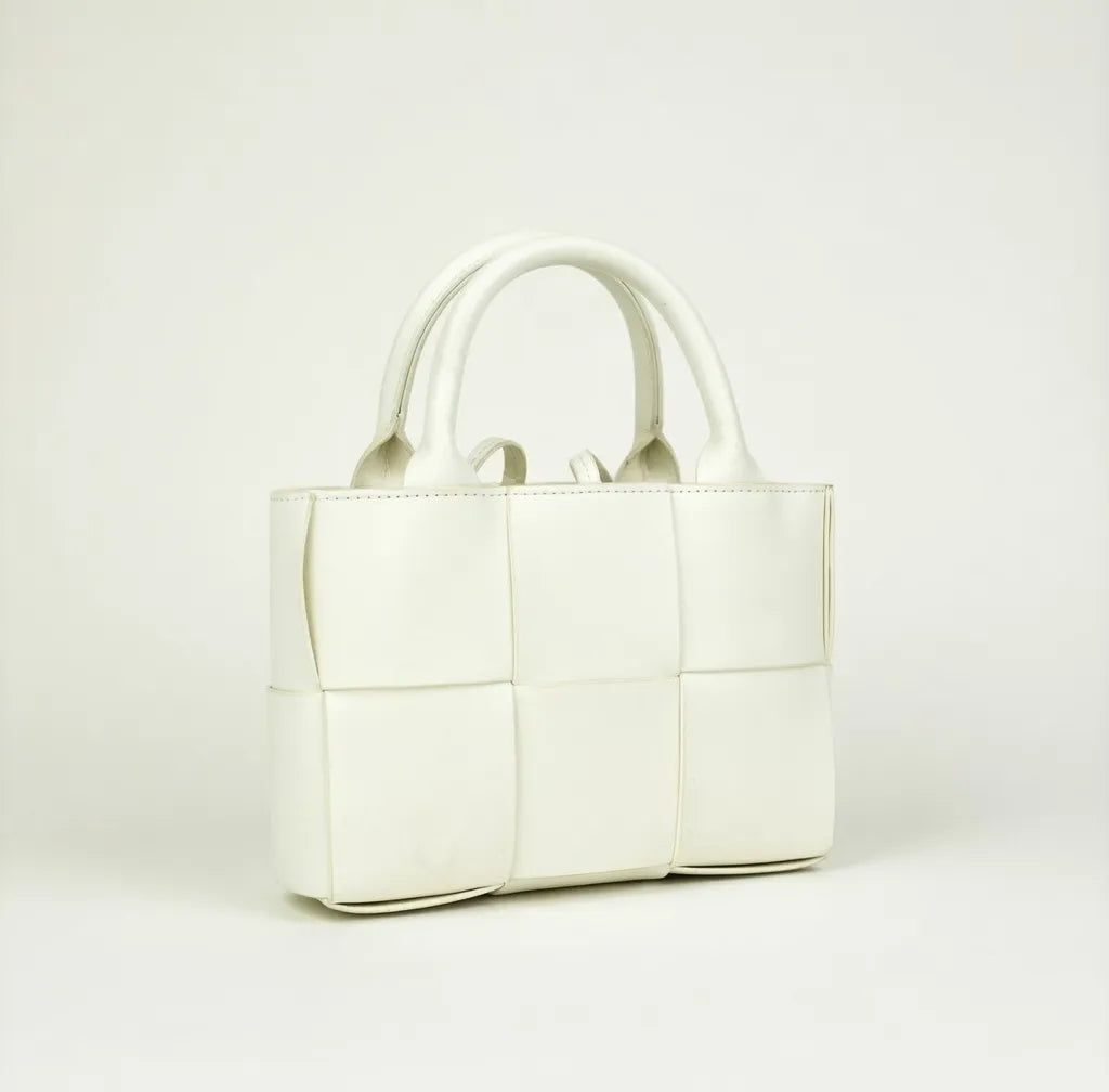 White handbag on a light gray background