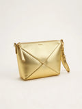 Gold handbag with a geometric design on a light beige background