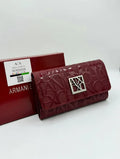 Red Armani wallet with branded box on a white background