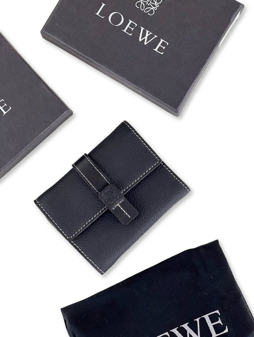 Black leather wallet with Loewe branding on a white background