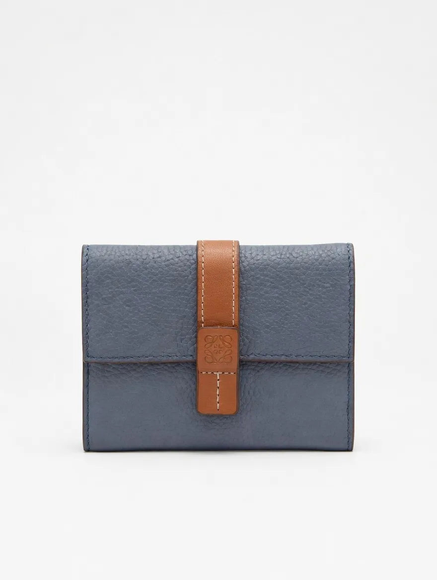 Blue wallet with a brown strap on a light gray background