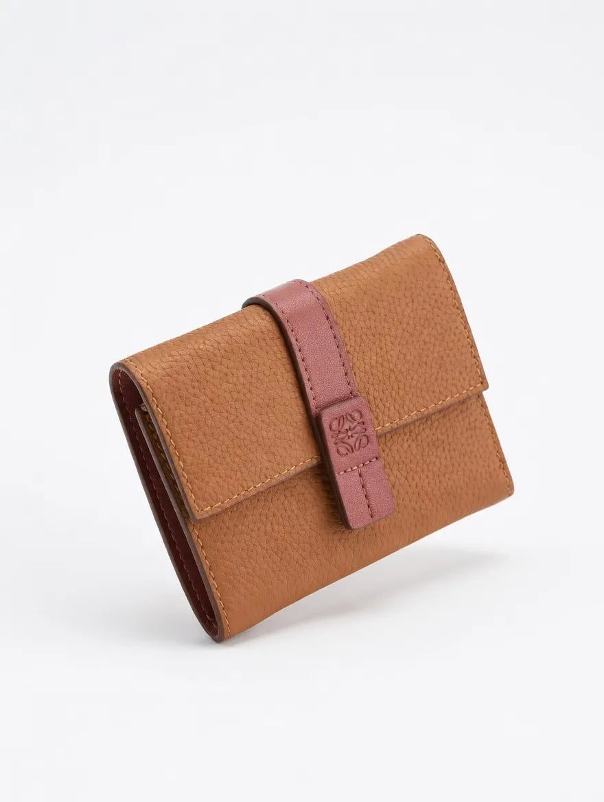 Brown leather wallet with a strap on a white background