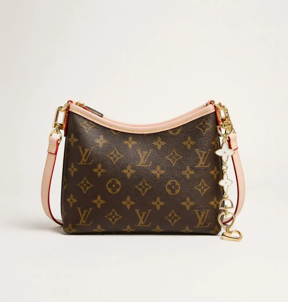 Designer handbag with monogram pattern on a light beige background