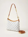 Designer handbag with monogram pattern on a light background