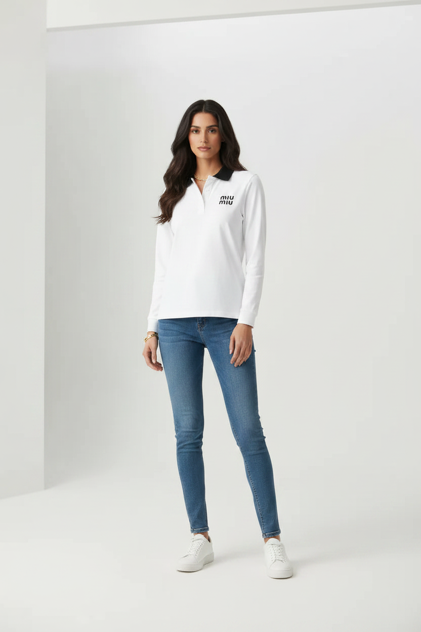 Female model wearing Miu Miu white long sleeve polo shirt black collar MIU MIU logo blue slim jeans white sneakers gray studio background