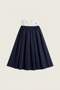 Polo Ralph Lauren Two-Tone Midi Skirt - white ribbed knit waistband with red polo pony logo and navy blue pleated skirt on off-white background