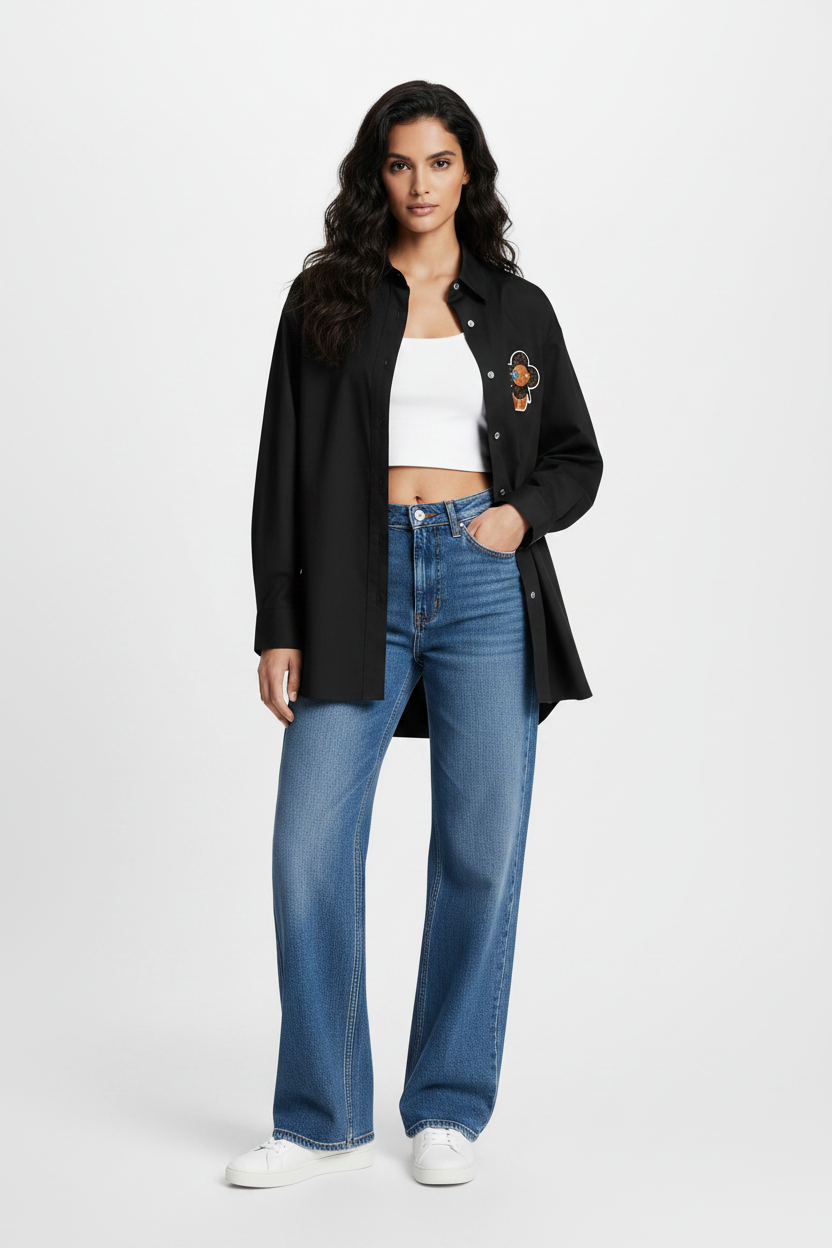 Louis Vuitton Vivienne Patch Oversized Black Shirt – model wearing shirt open over white crop top with blue wide-leg jeans and white sneakers, styled casual luxury look