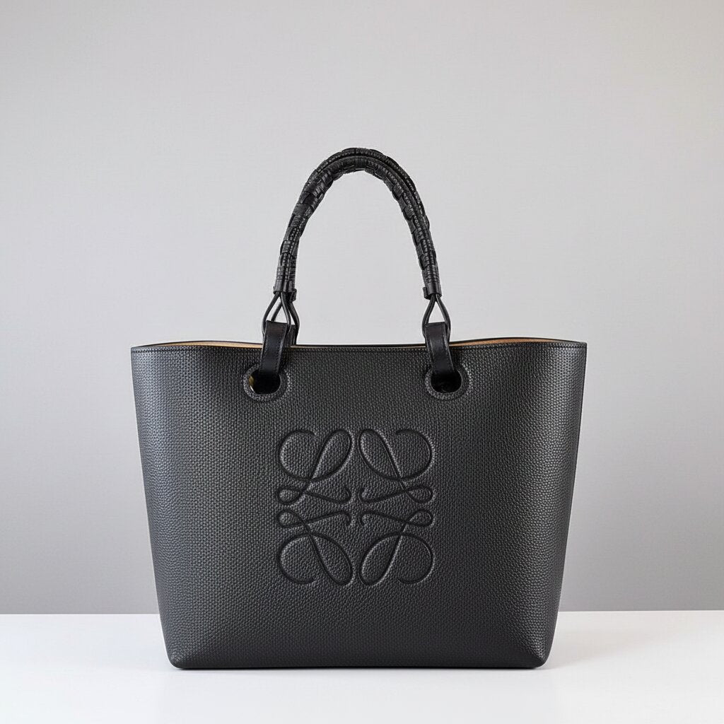 Loewe Anagram Tote Bag in Black Pebbled Leather with Black Rattan Handles - Light Gray Background - Front View