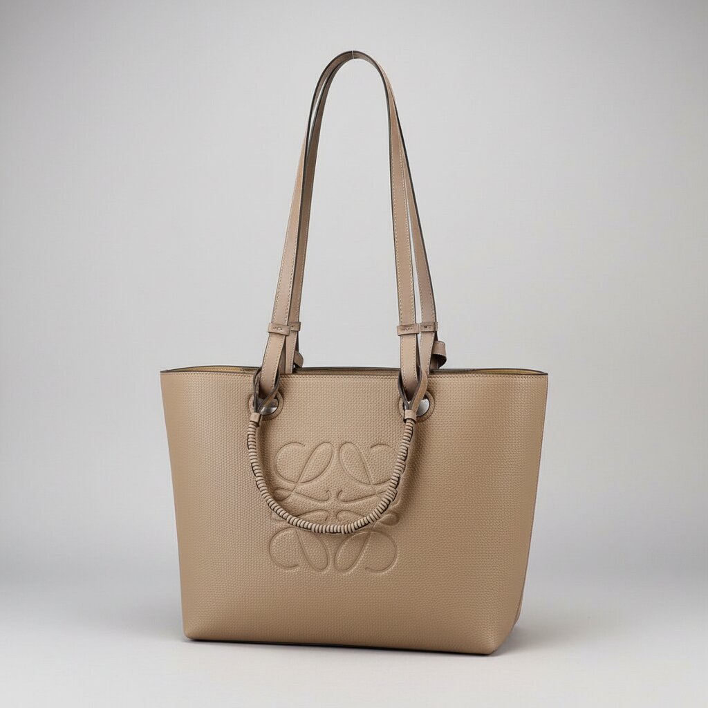 Loewe Anagram Tote Bag in Taupe Beige Pebbled Leather with Long Shoulder Straps and Rattan Handles - Light Gray Background - Front Angled View