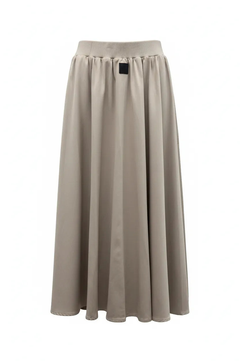 Beige skirt with a black button on a white background