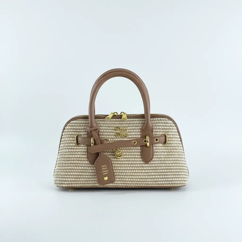 Woven handbag with brown leather accents on a light gray background