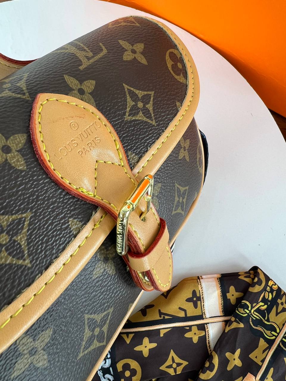 Louis Vuitton handbag with monogram pattern on a white surface