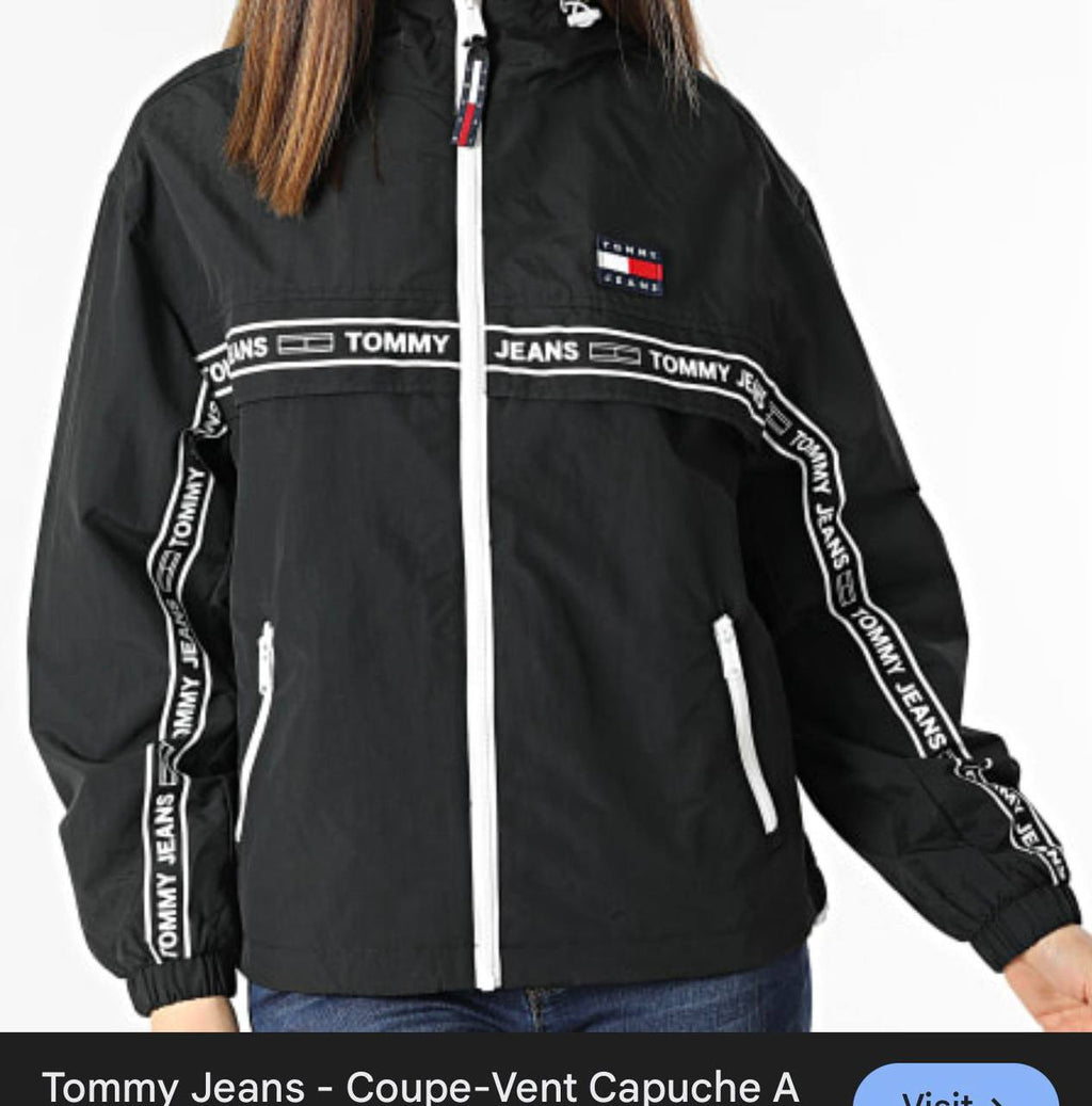Black Tommy Jeans jacket with brand logos on a white background