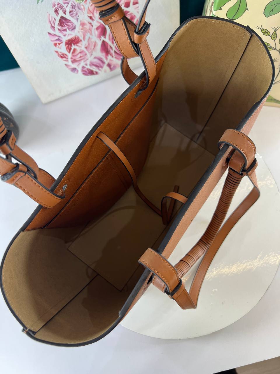 Loewe Anagram Tote Bag - Open Top Interior View Showing Tan Caramel Leather Lining and Structured Divider Pocket - Light Gray Background