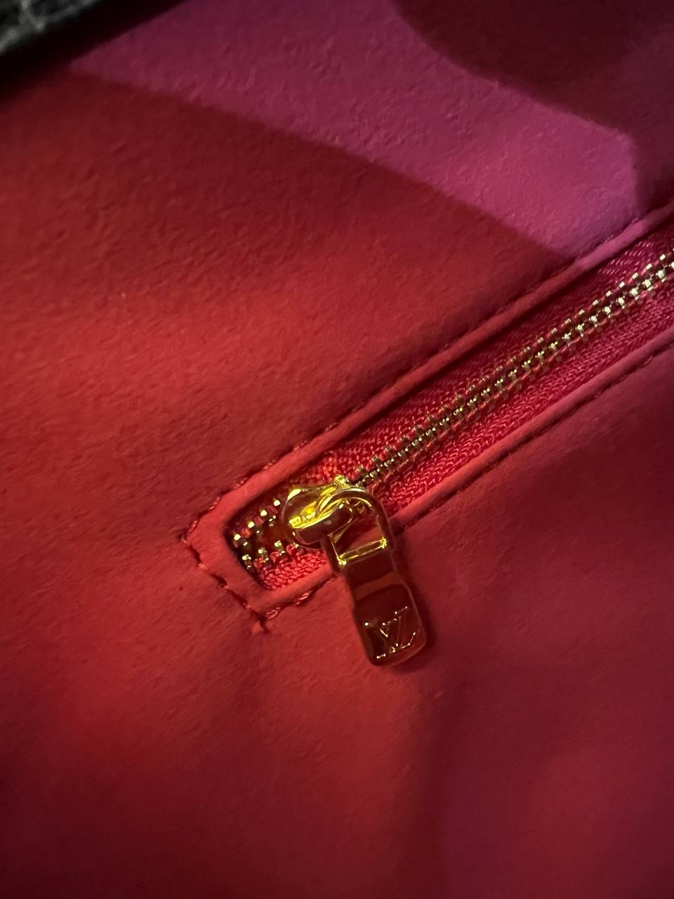 Close-up of a red zipper on a red background