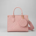 Pink handbag with matching round pouch on a light gray background