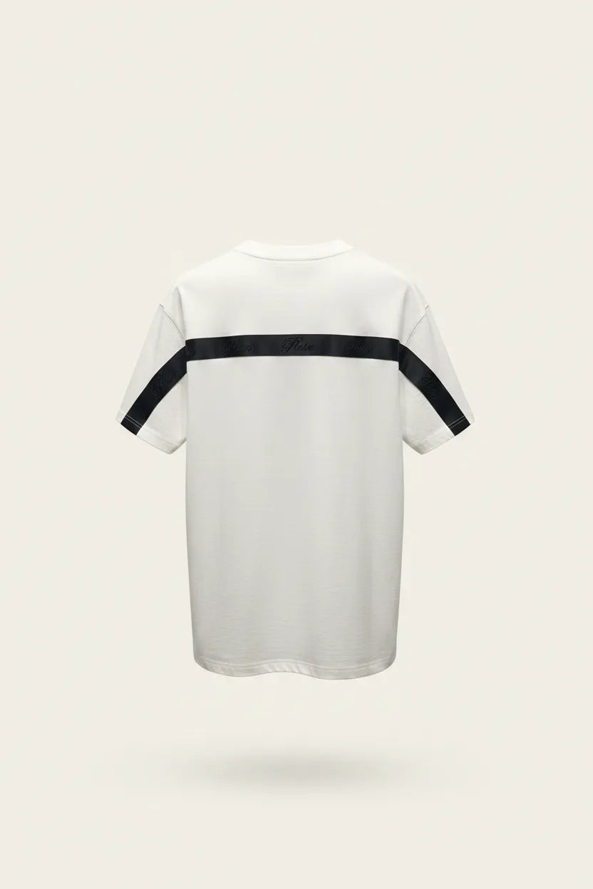 White t-shirt with black accents on a light beige background