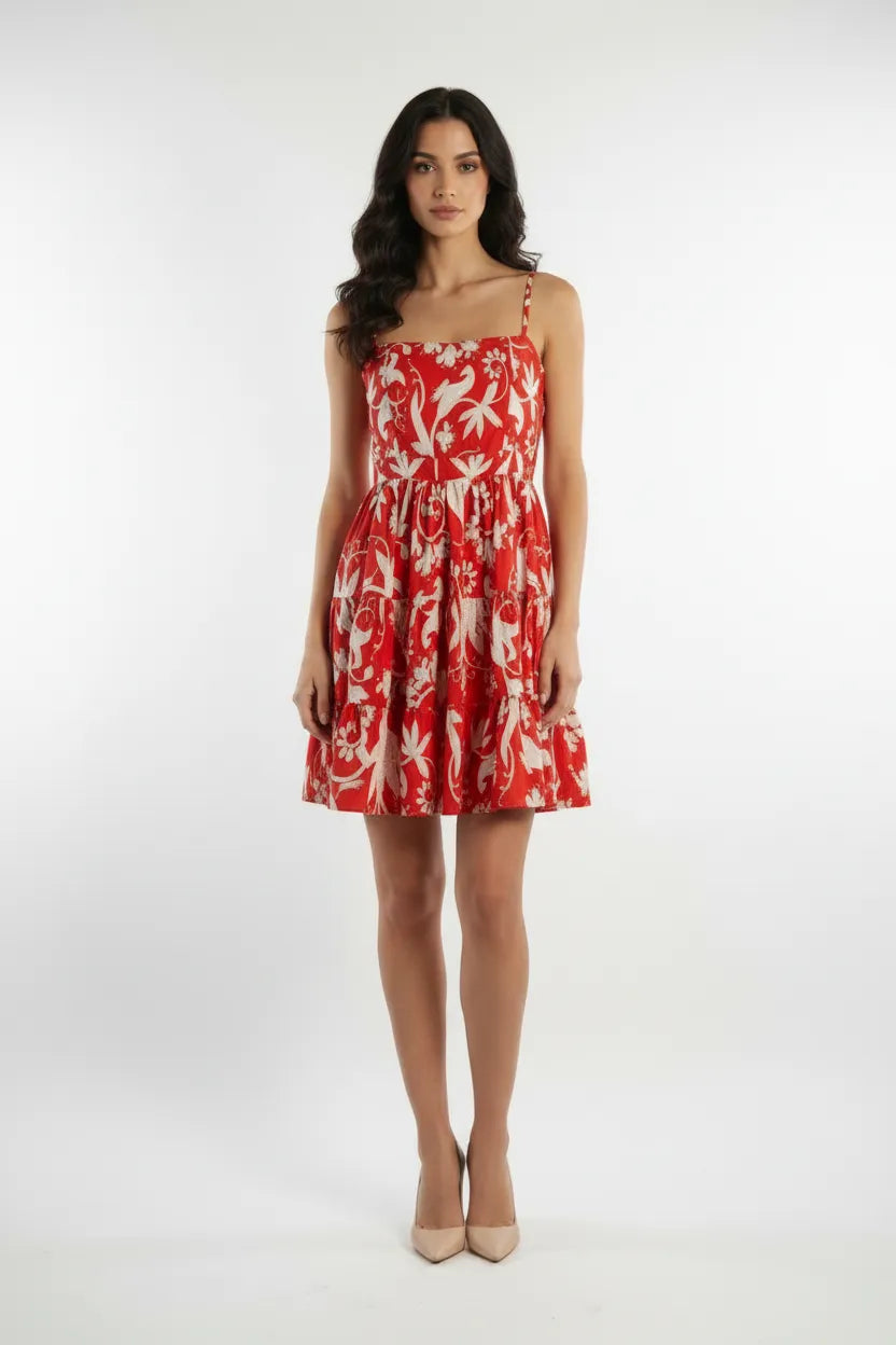 Woman wearing a red floral dress on a white background