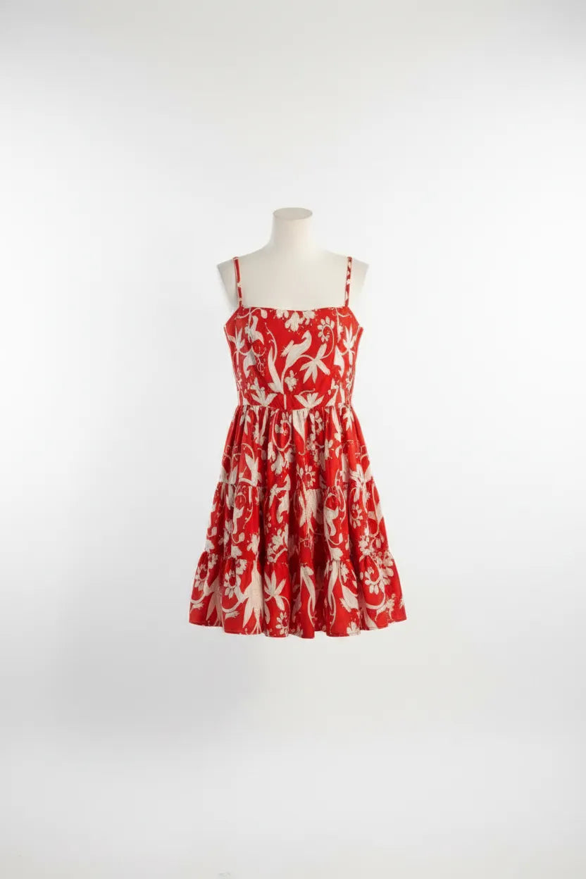 Red dress with white floral pattern on a mannequin against a white background