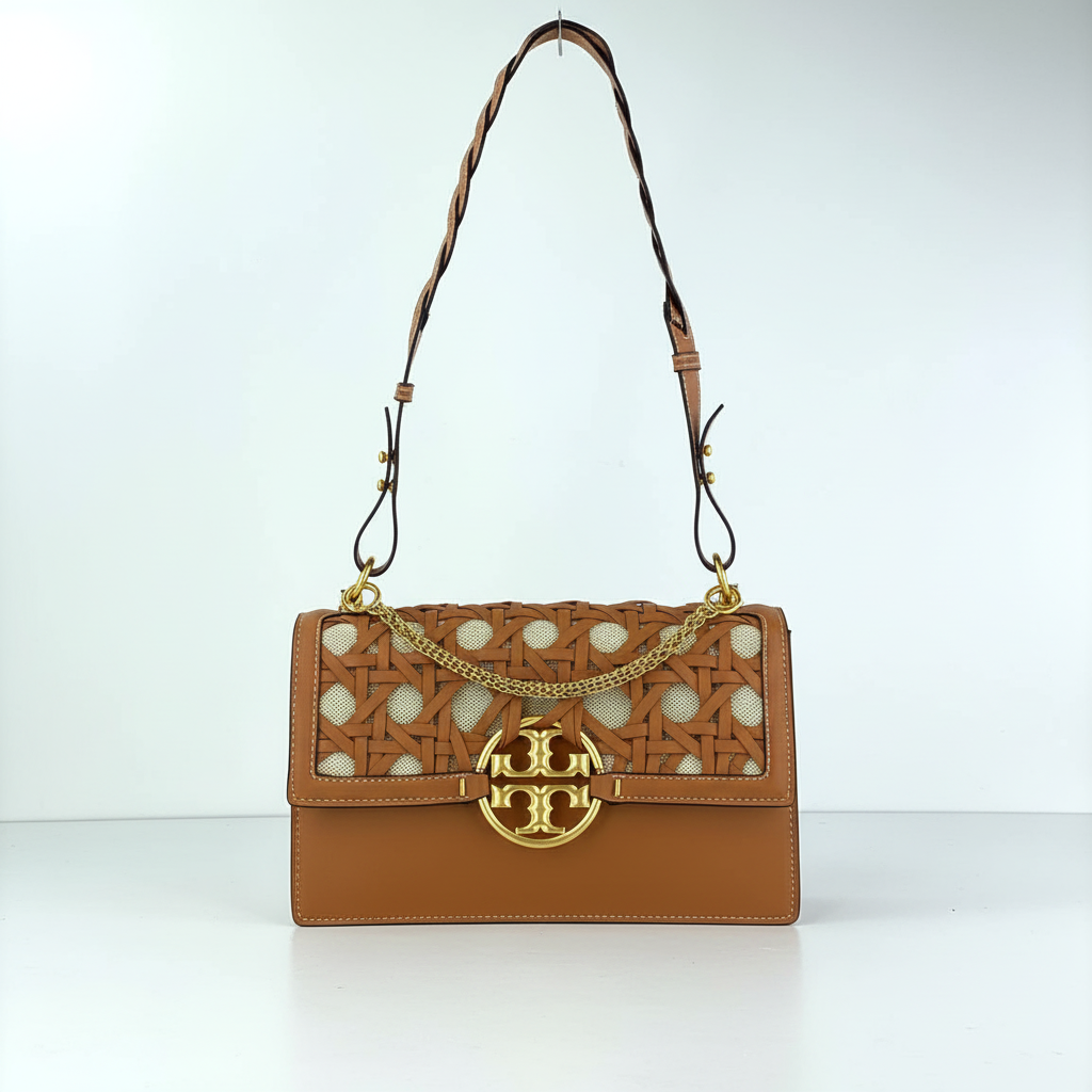 Tory Burch brown woven leather bag detail shot showing intricate basketweave texture and gold hardware"
