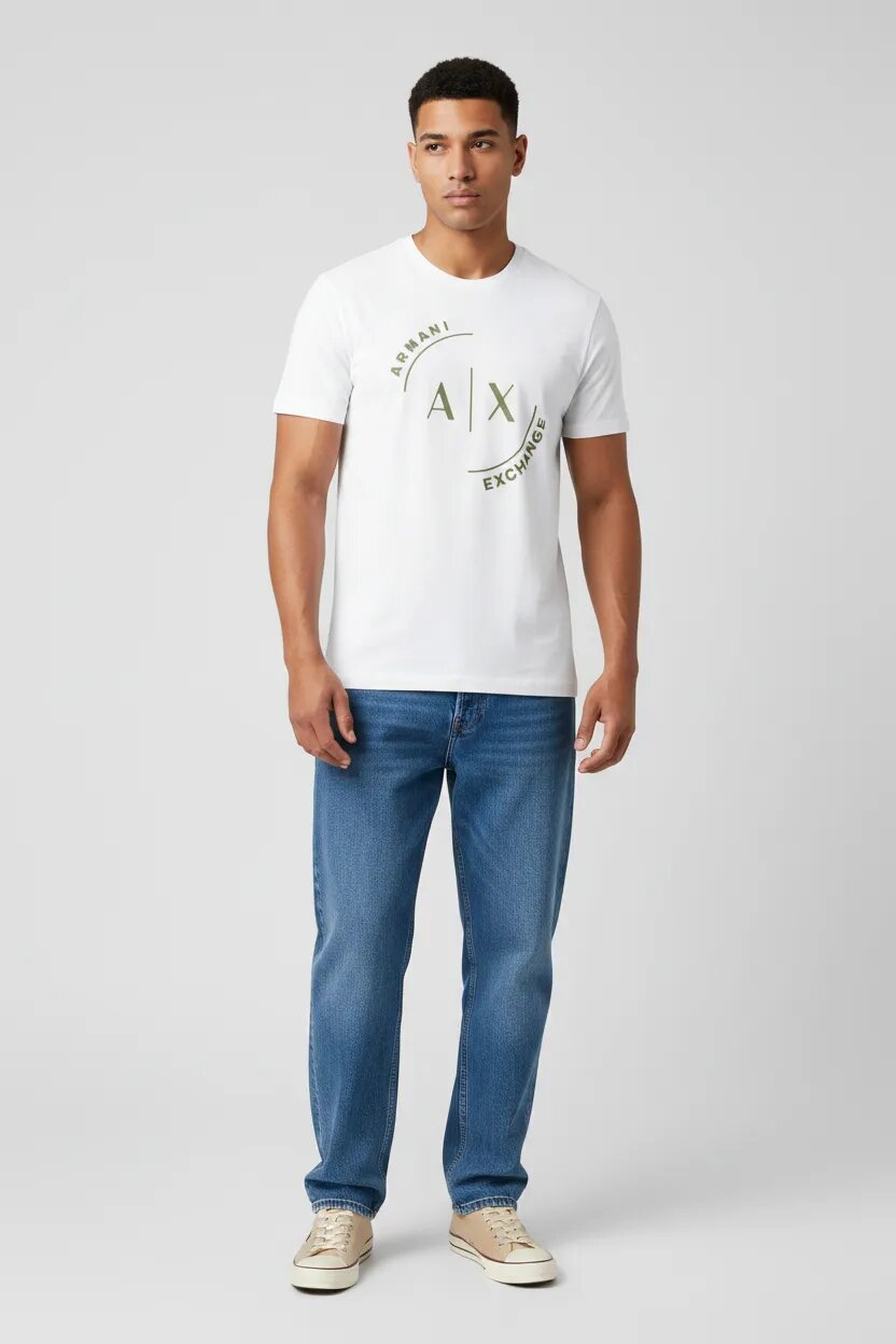 Male model wearing Armani Exchange white AX logo t-shirt with loose fit blue jeans and beige sneakers